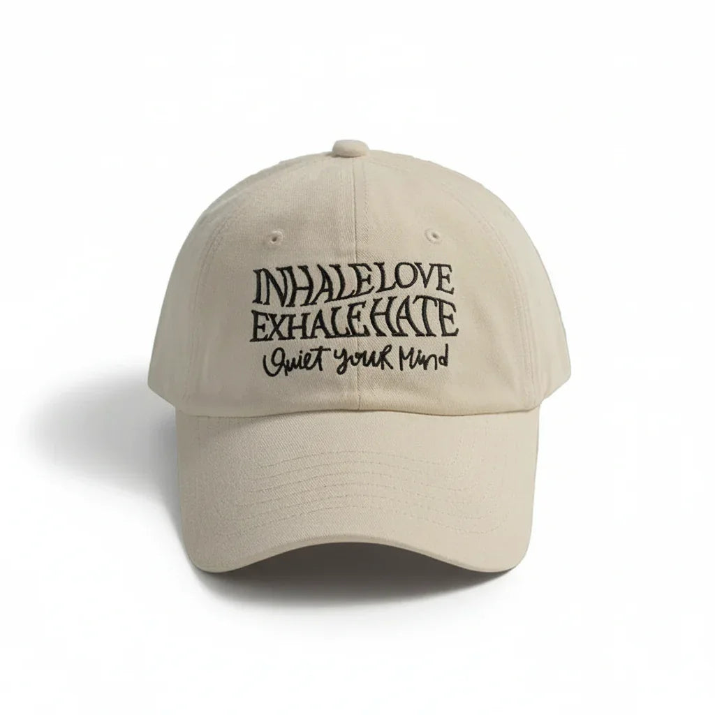 Beige dad hat with 'Inhale Love Exhale Hate Quiet Your Mind' embroidered text, minimalist streetwear style