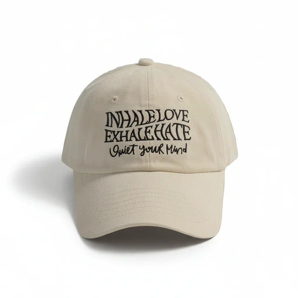 Beige dad hat with 'Inhale Love Exhale Hate Quiet Your Mind' embroidered text, minimalist streetwear style