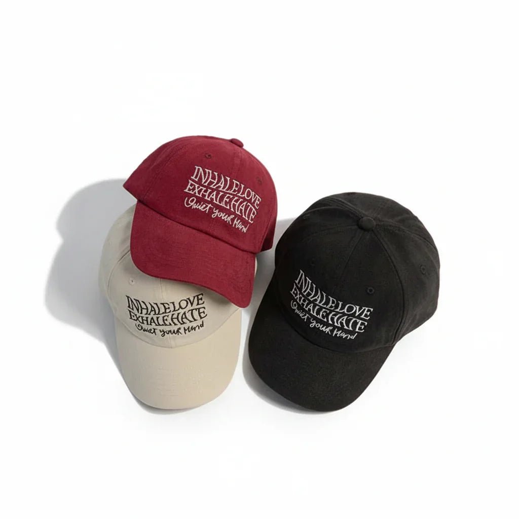 Three embroidered baseball caps in red, beige, black with 'Inhale Love Exhale Hate' quote, stylish streetwear accessory